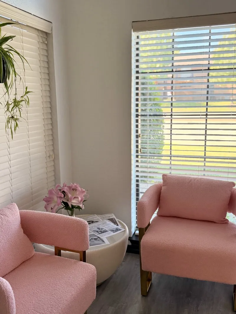 Pink armchairs in the Beauty Blends waiting area